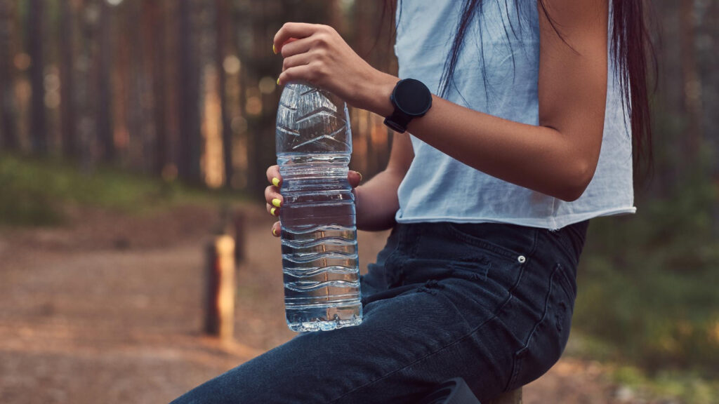 person drinking water throughout the day for better health