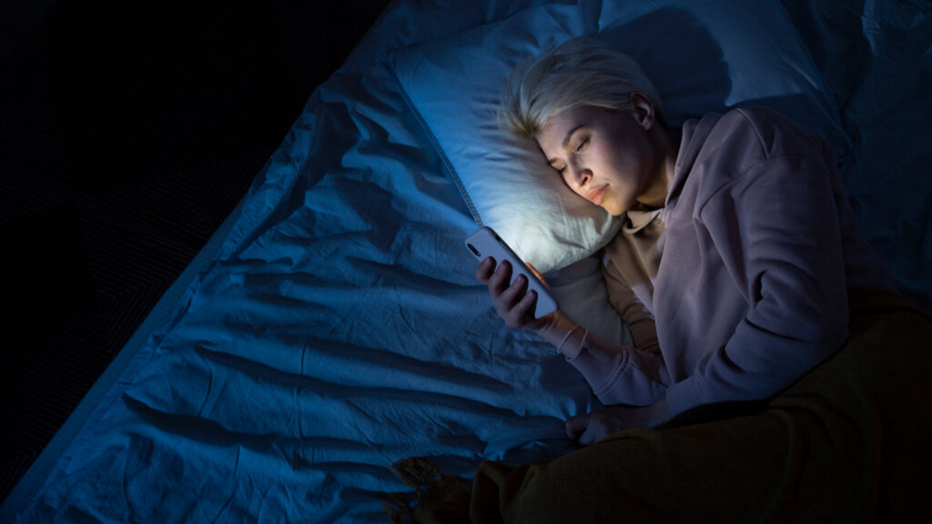 person avoiding smartphone before sleep for better rest